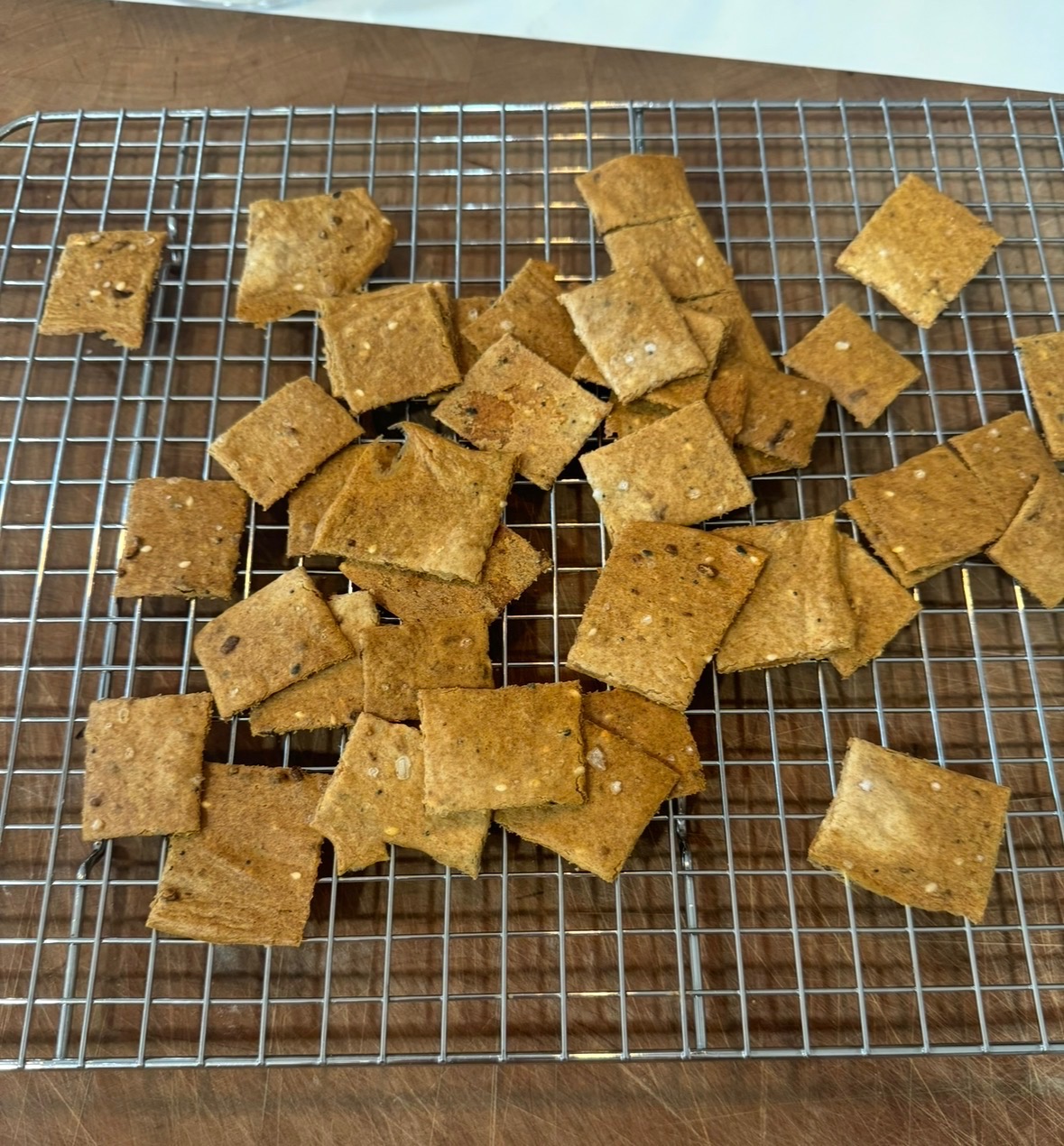 Amanda's farmhouse sourdough crackers cooling on a rack